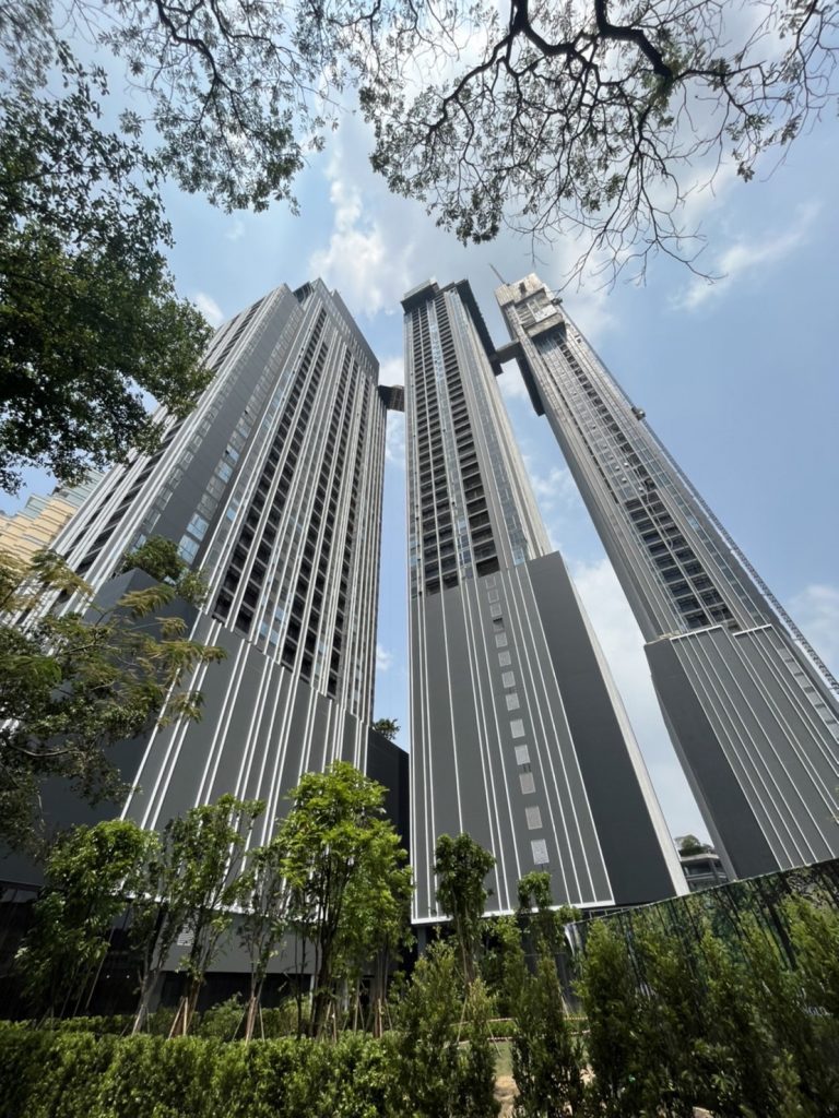 Park Origin Thonglor — facade of the towers behind the trees