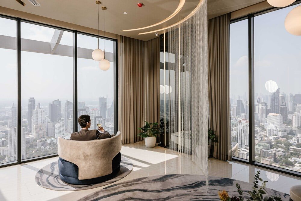 Park Origin Thonglor — panoramic windows and an armchair with a city view